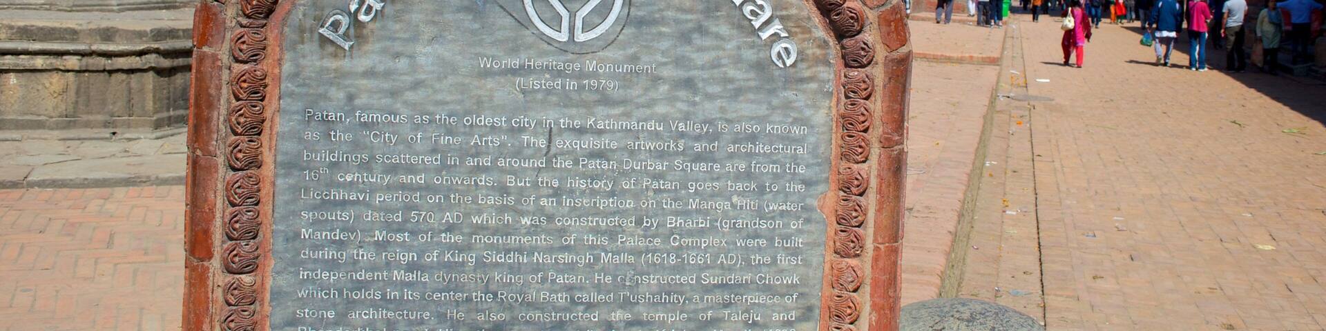 A historical plaque at Patan Durbar Square, detailing its heritage and architecture.