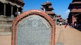 A historical plaque at Patan Durbar Square, detailing its heritage and architecture.