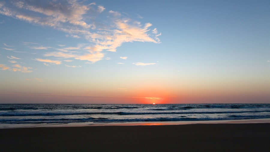 Tofo Beach which includes a sunset, a beach and general coastal views