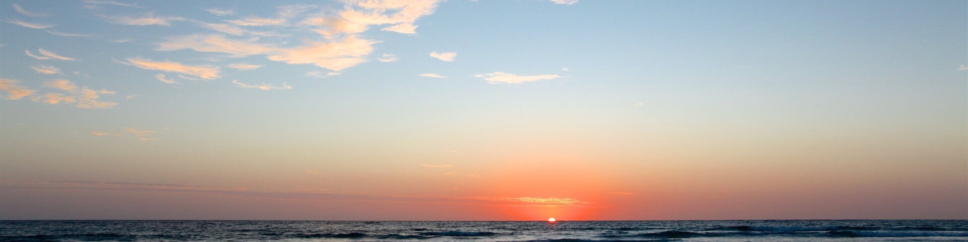 Tofo Beach which includes a sunset, a beach and general coastal views