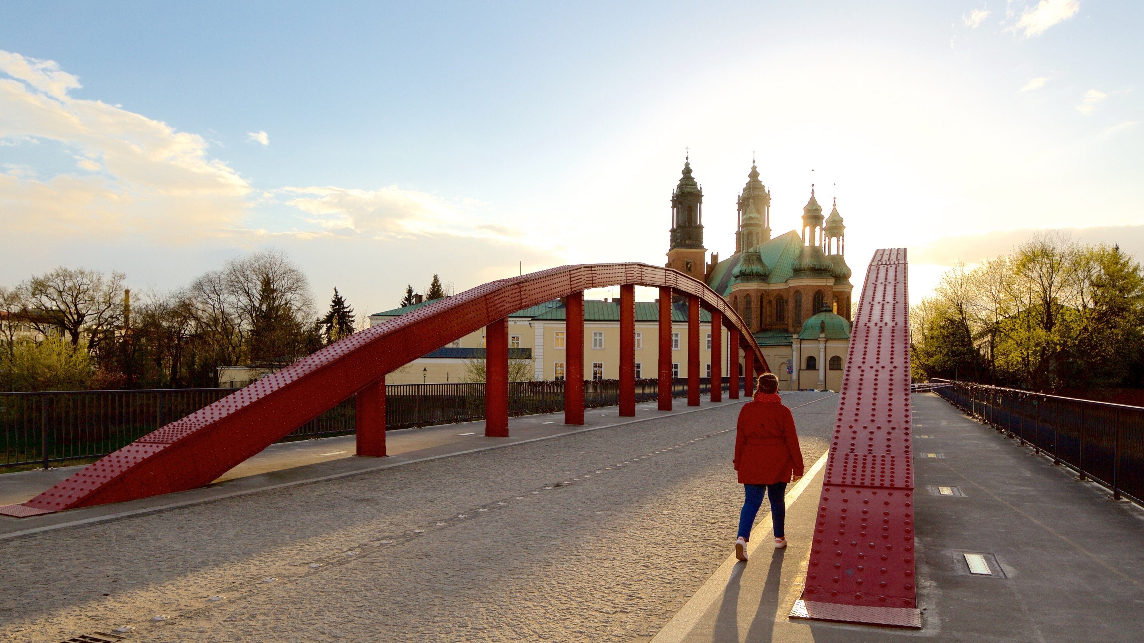 Archcathedral Basilica of St. Peter and St. Paul which includes a bridge and a sunset as well as an individual femail
