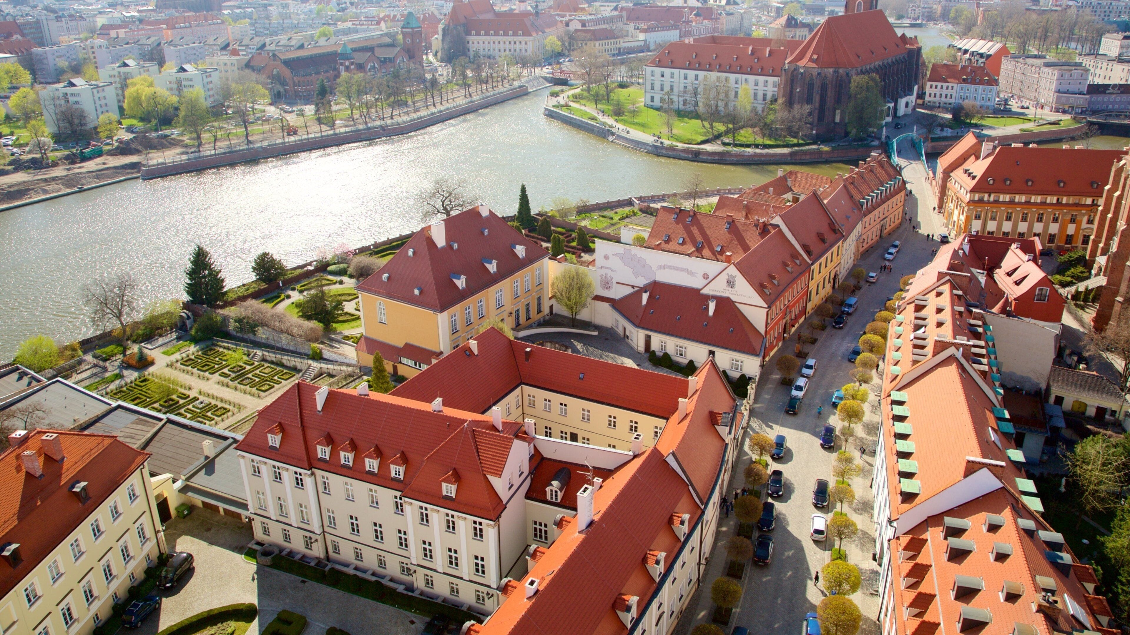 Wroclaw Cathedral which includes a river or creek and a city