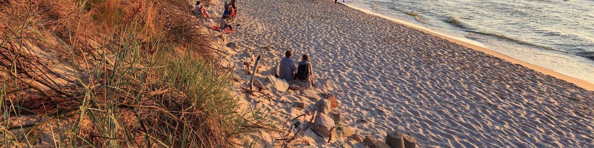 Beach on polish coast of Baltic Sea in middle of holiday season at sunset - in Rowy, between Ustka and Leba; Shutterstock ID 480041422