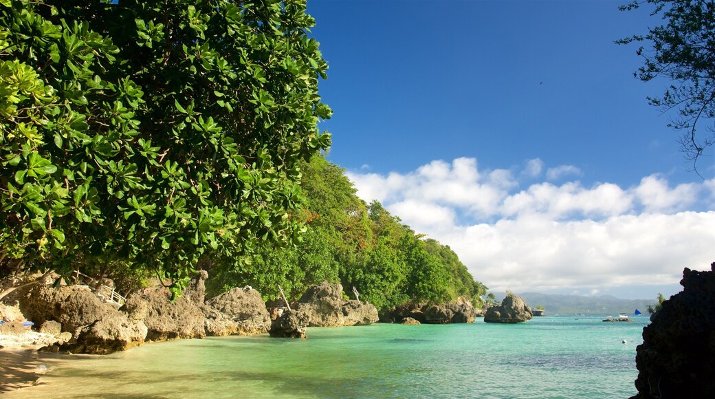 Balinghai Beach showing tropical scenes, rugged coastline and a bay or harbor