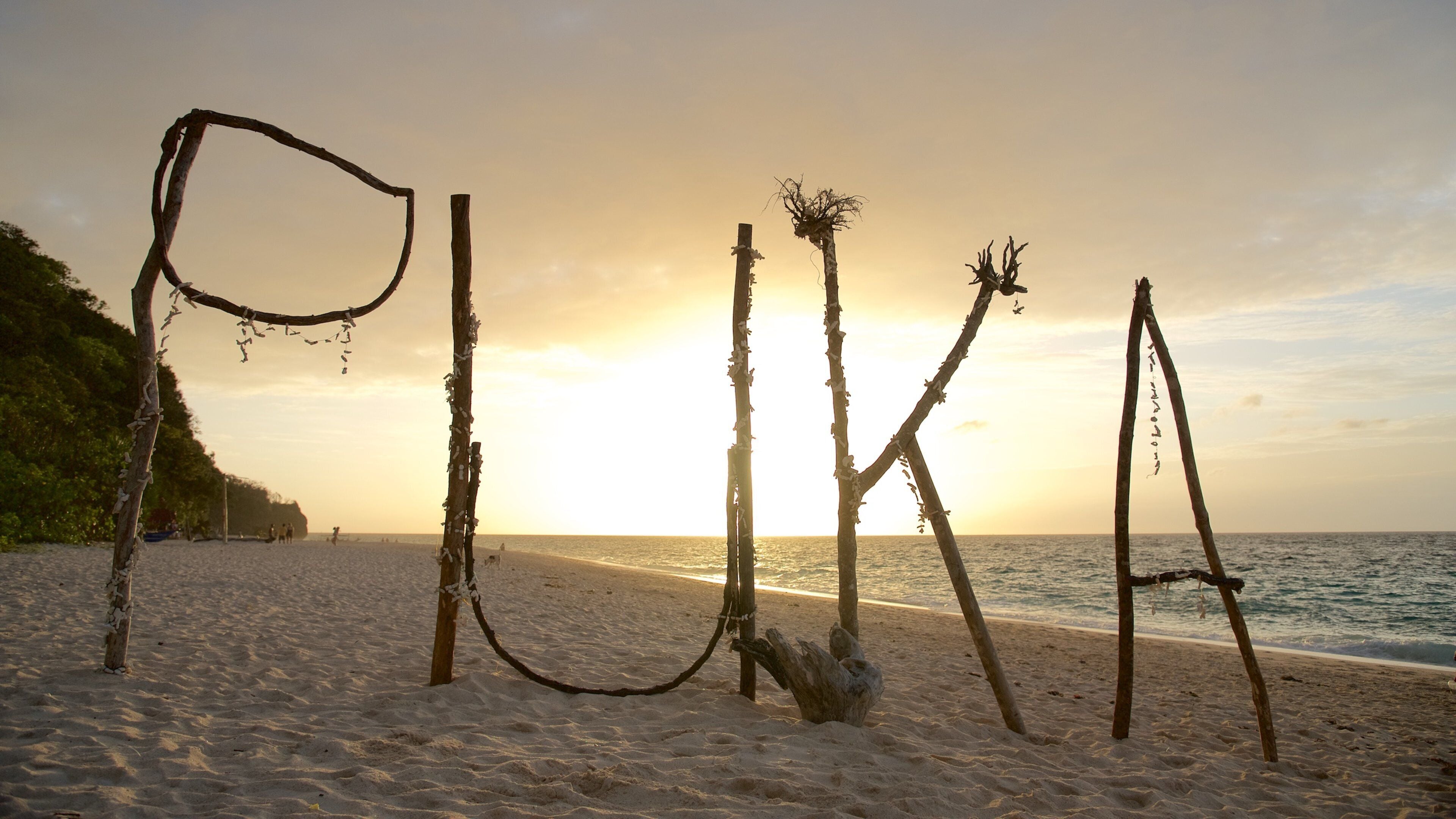 Puka Beach which includes a beach, tropical scenes and a sunset