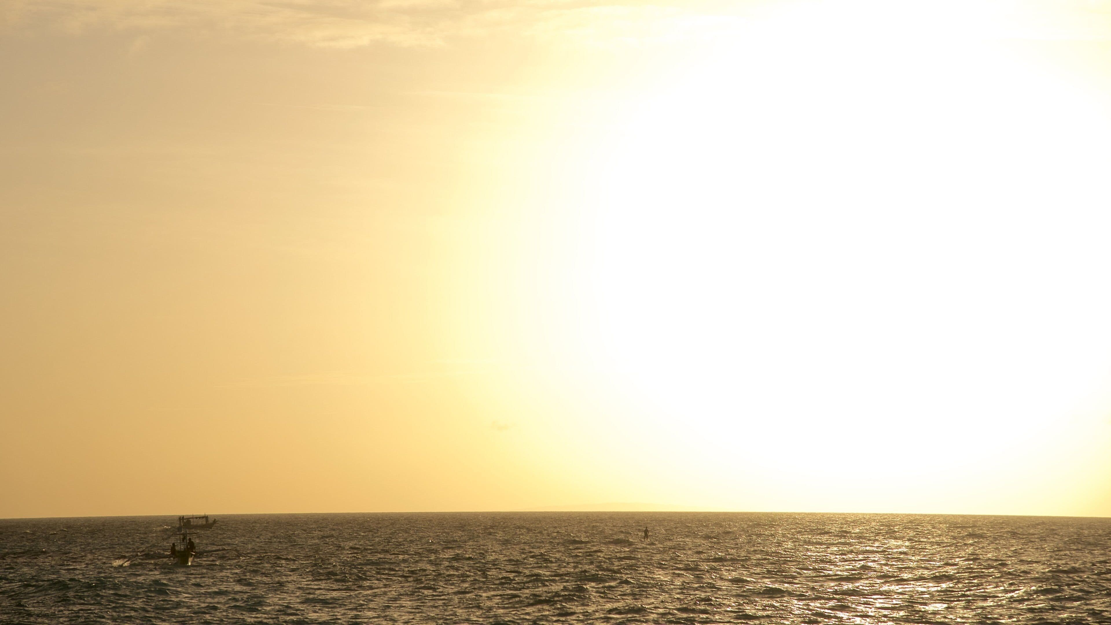 Puka Beach which includes surf, a sunset and general coastal views