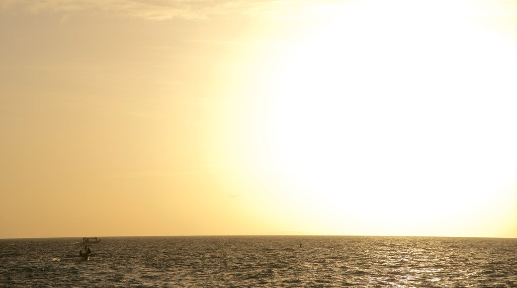 Puka Beach which includes surf, a sunset and general coastal views