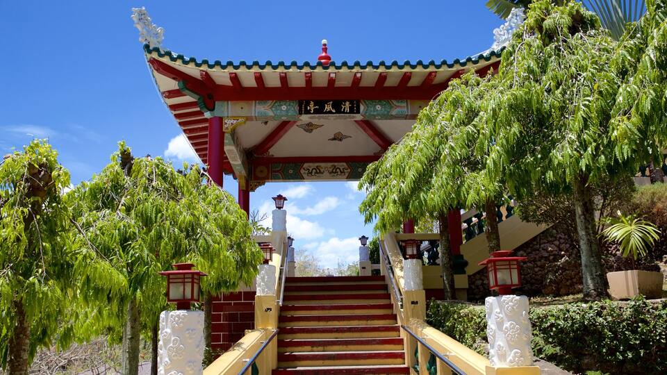A traditional Chinese gate with red and white colors, leading to a staircase.