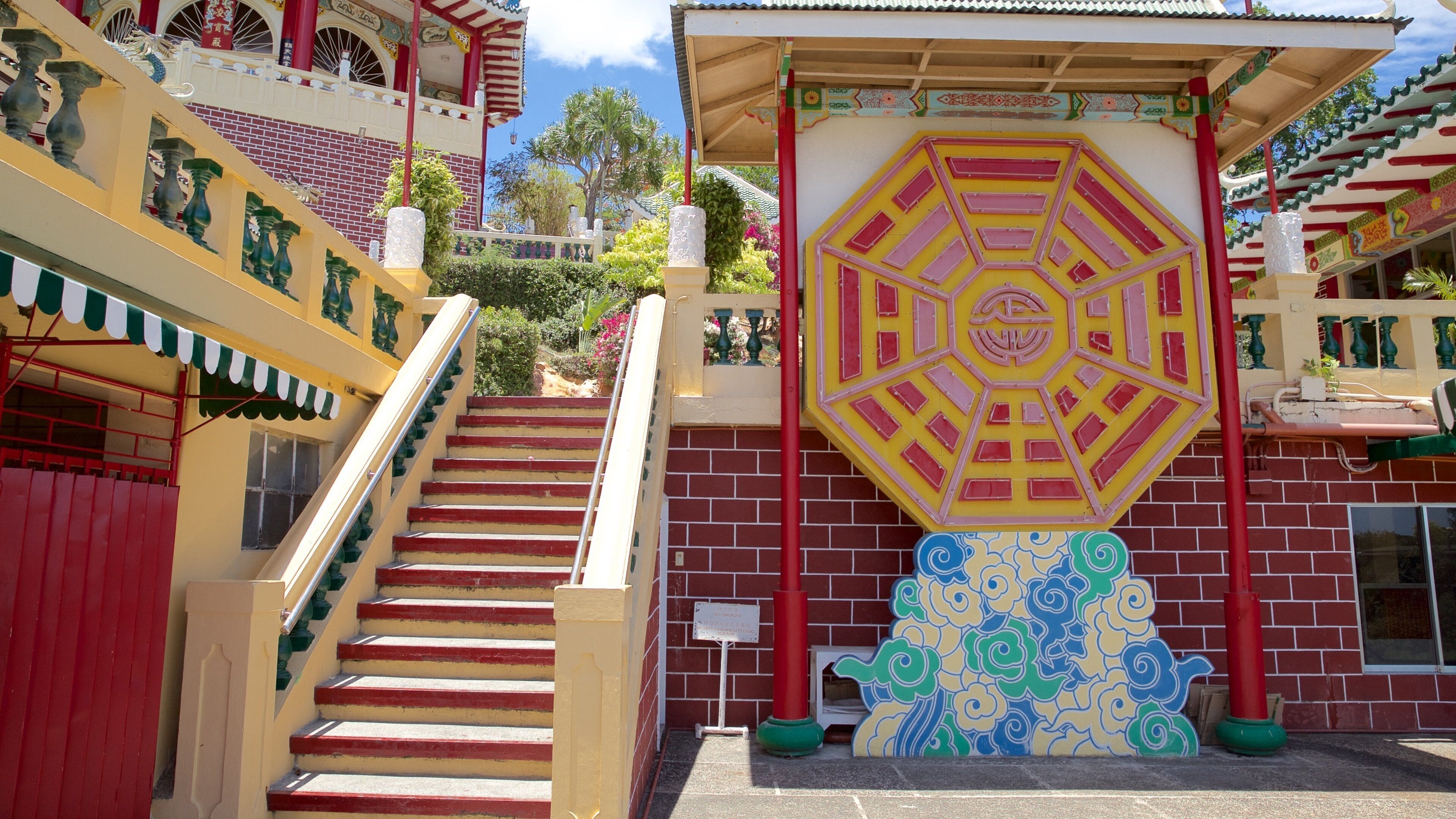 A staircase leading up to a building with colorful murals and traditional architectural elements.