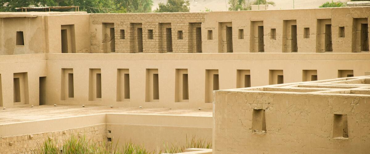 A traditional mud-brick building with multiple small windows and a flat roof.