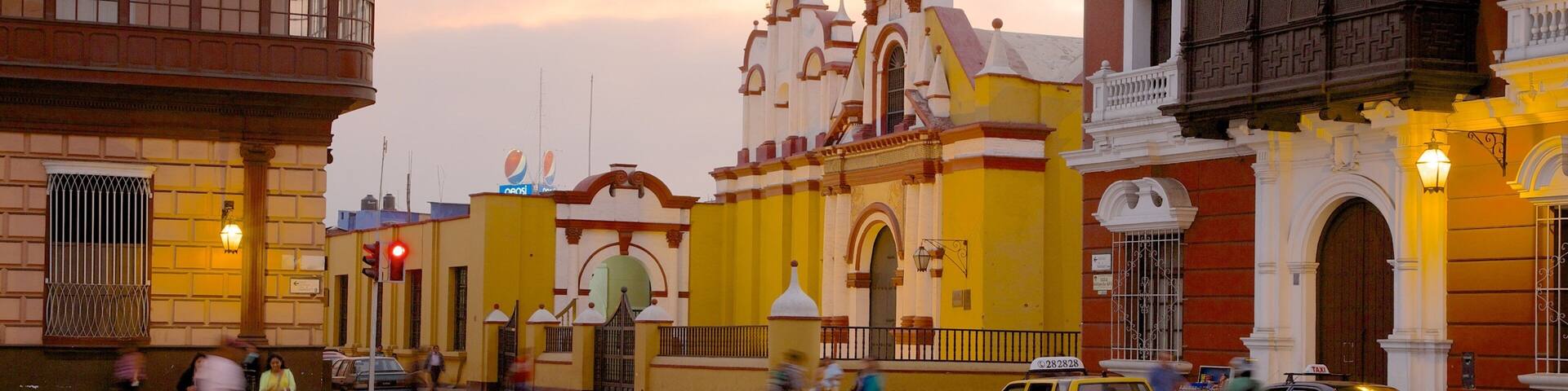 Trujillo Plaza de Armas featuring a sunset, a city and street scenes