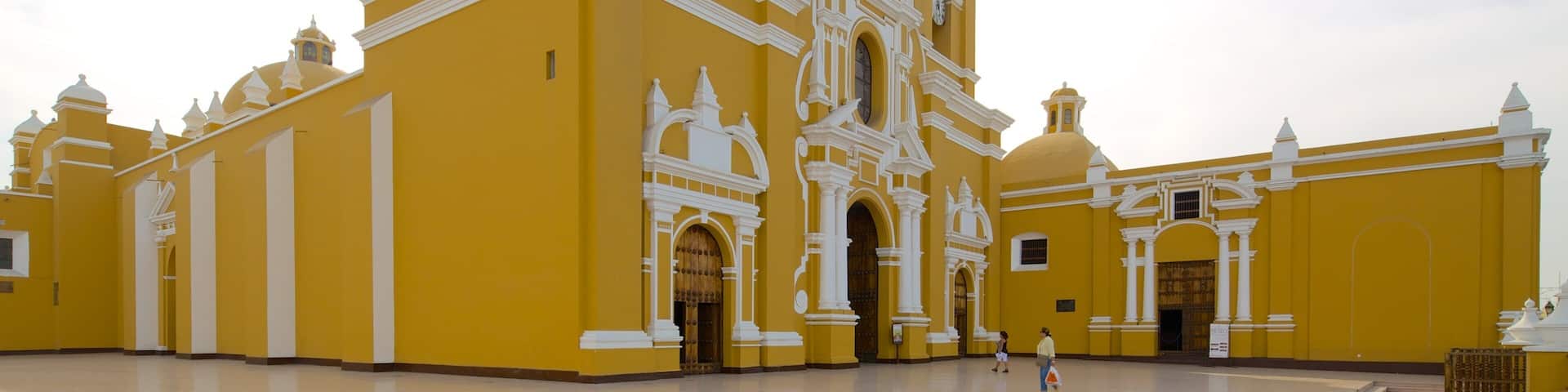 A large yellow church with multiple domes and bell towers.