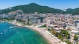 Aerial view of the main beach of Budva, lined with waterfront modern hotels along the coast of the Adriatic Sea in Montenegro