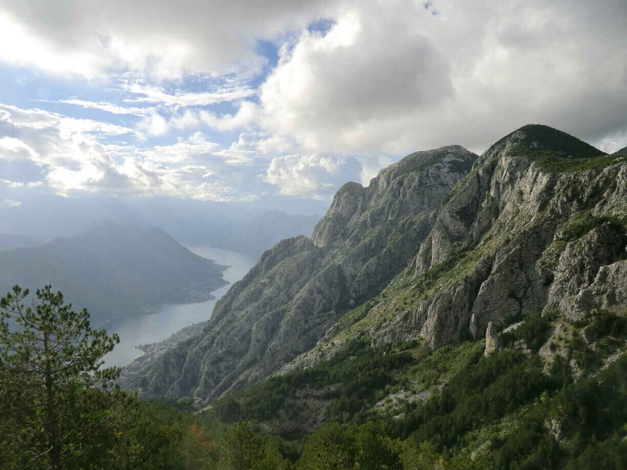 View over Boka bay from the winding road going from Kotor to Lovcen national park.

In the park there is a mausoleum, from which you have great views over the mountains (entrance fee both for the park and the mausoleum).
Unfortunately, there is no public transport to go to Lovcen, so we had to go by car (we asked the tourist office in Kotor for tours). Anyway, the best views over the bay are from the road leading to the park, so it is convenient to use private transport and stop along the way to take pictures.
#NationalPark