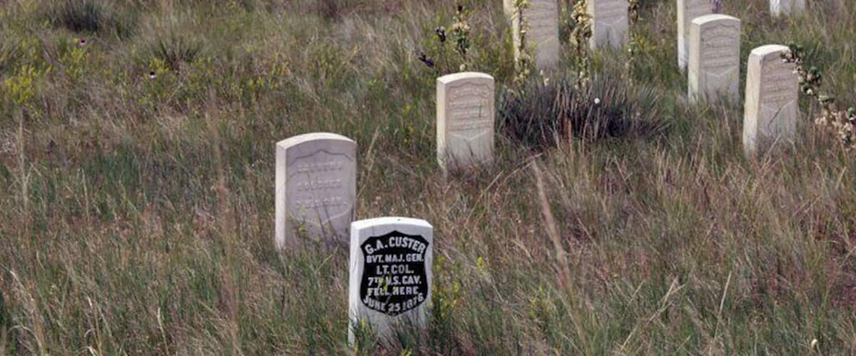 A cemetery with headstones, including one marked 'C.A. CUSTER'.