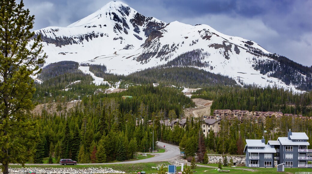 View of Lone Mountain with buildings and pine trees on the foot of the mountain, Big Sky, Montana, USA