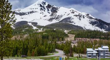 View of Lone Mountain with buildings and pine trees on the foot of the mountain, Big Sky, Montana, USA