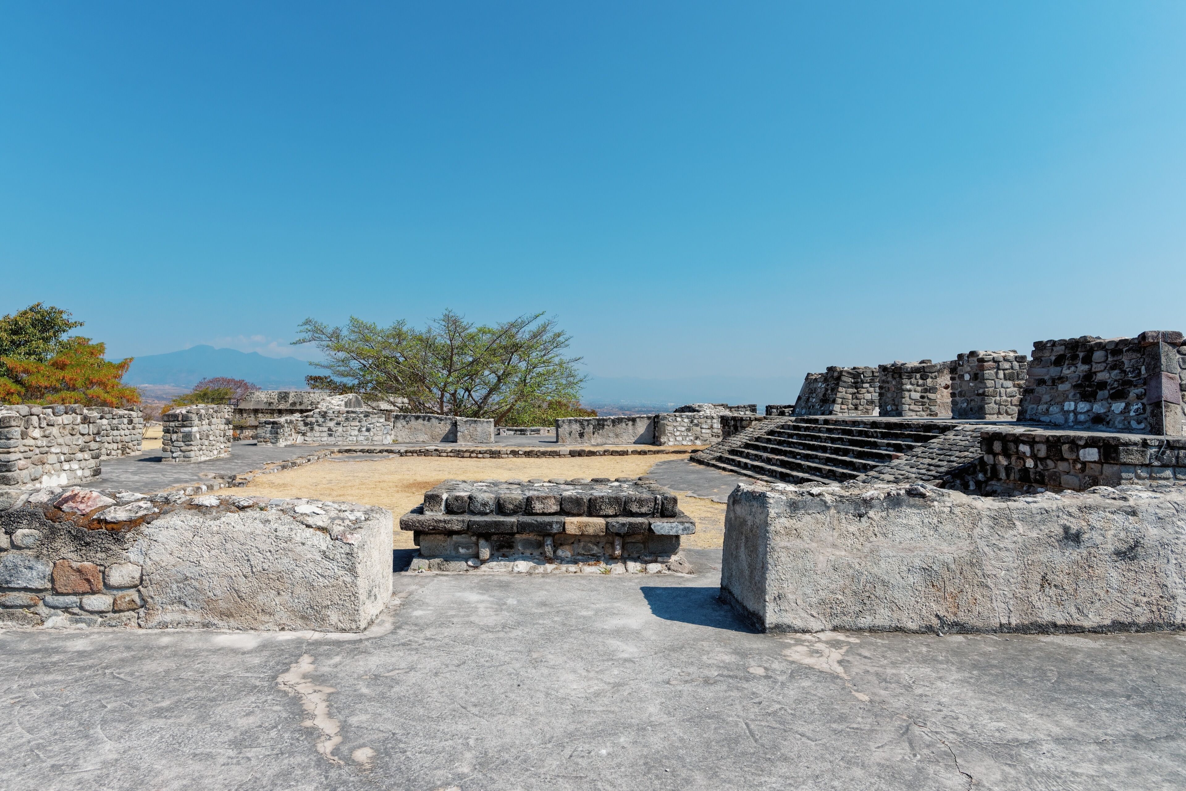 Top view of the area and the ruined ancient step pyramids on top of the mountain, buildings and masonry, architecture. City in Mexico Xochicalco