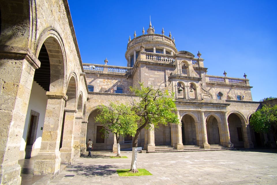 A historic building with arched walkways and a central dome.