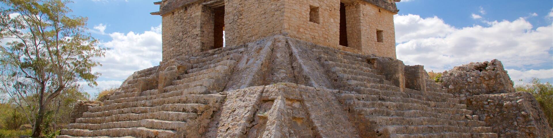 A stone pyramid structure with a flat top and a staircase leading up to it.