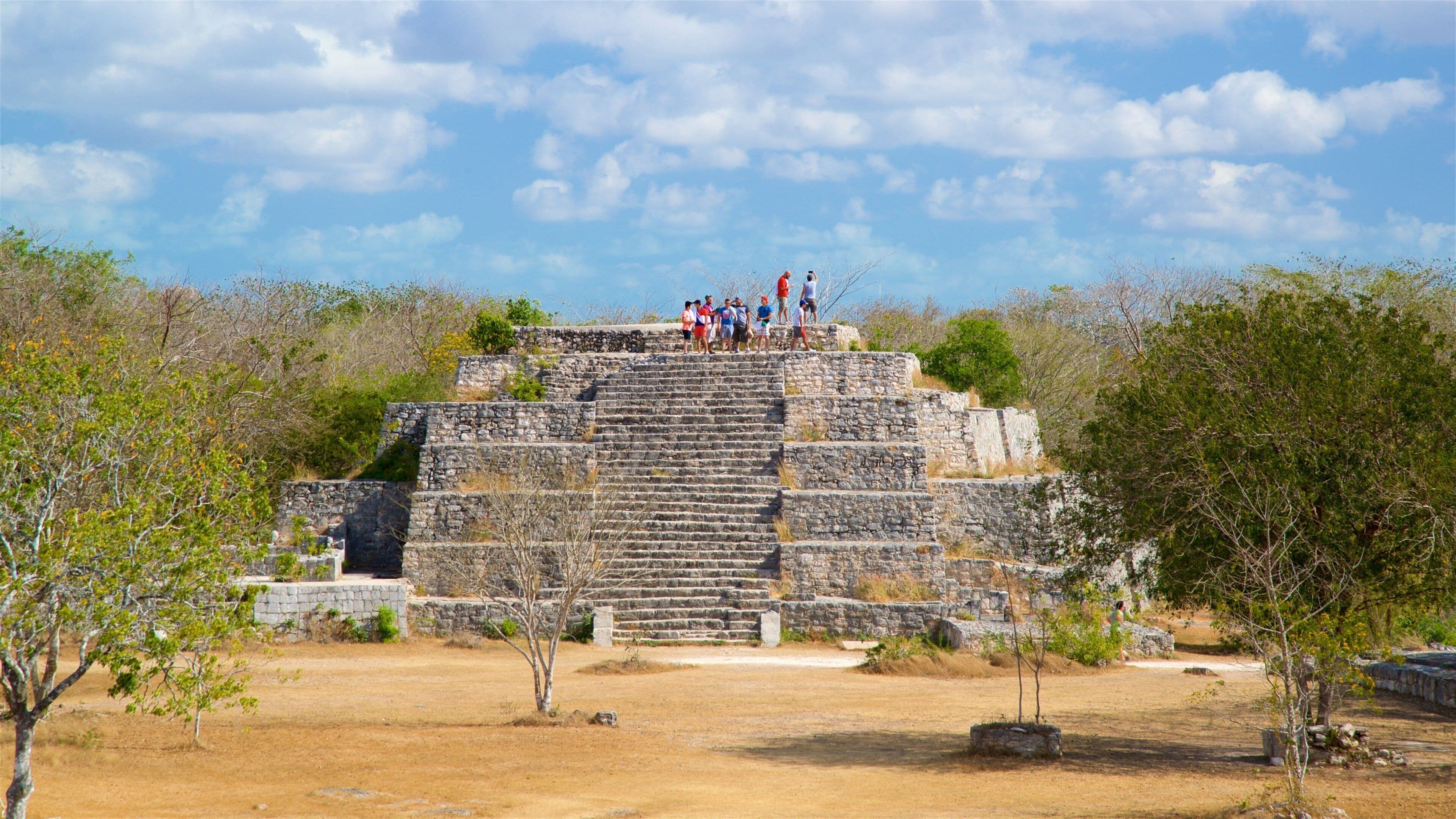 Dzibilchaltun Ruins which includes heritage elements and tranquil scenes as well as a small group of people