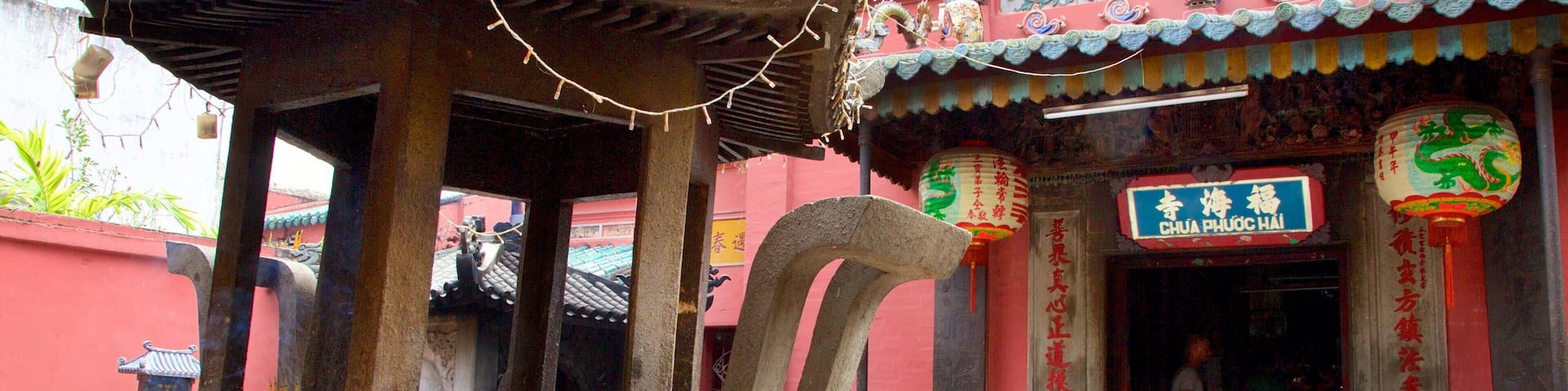 A traditional Chinese architectural structure with a curved roof, a stone pillar, and a signboard with Chinese characters.