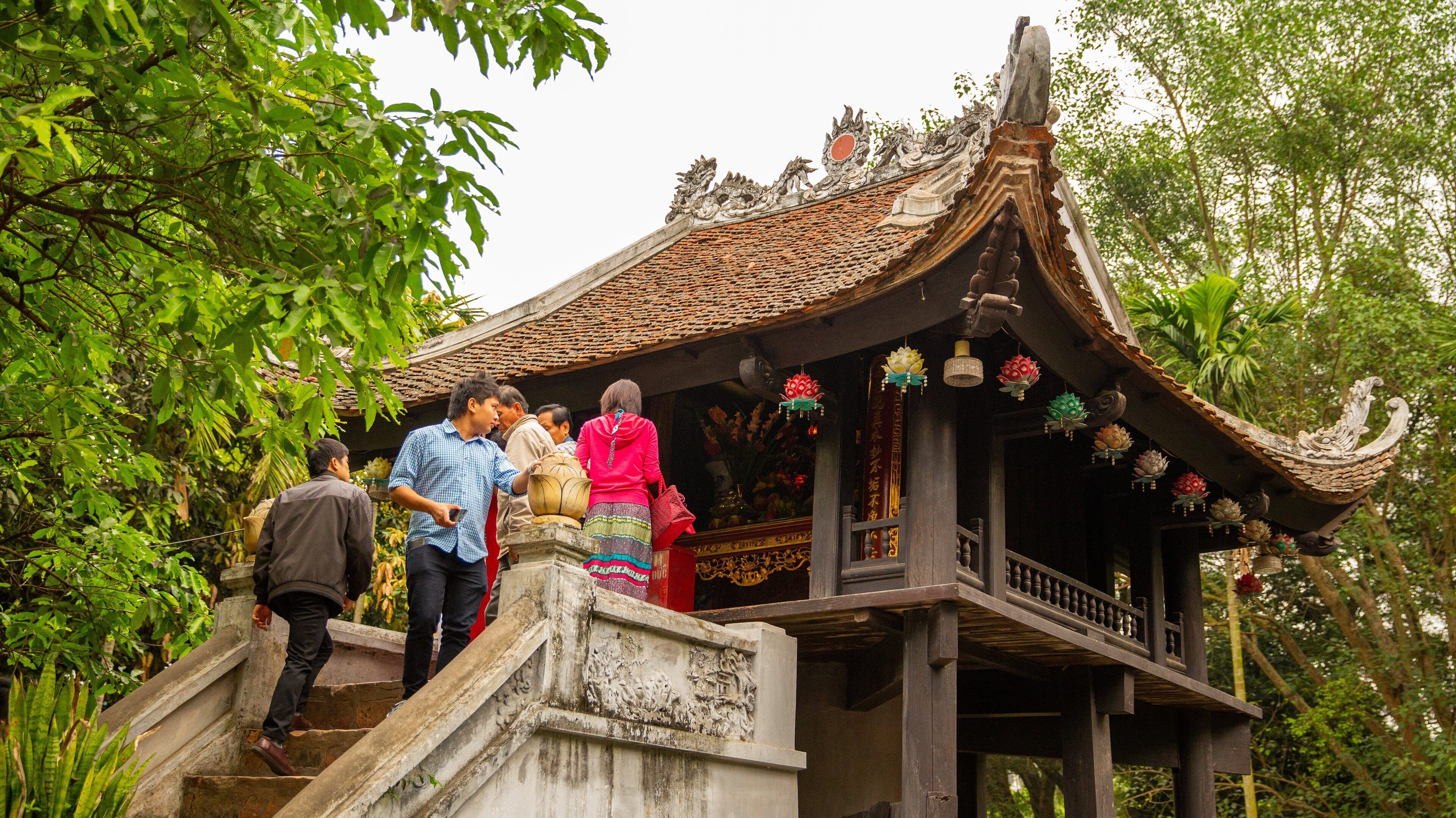 Ho Chi Minh Museum featuring heritage architecture as well as a small group of people