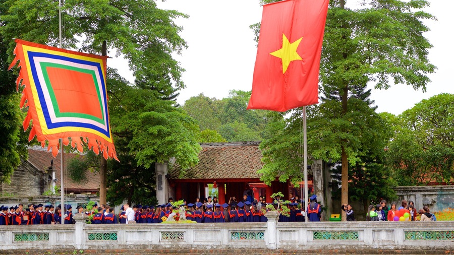 Temple of Literature which includes a garden and a temple or place of worship as well as a large group of people