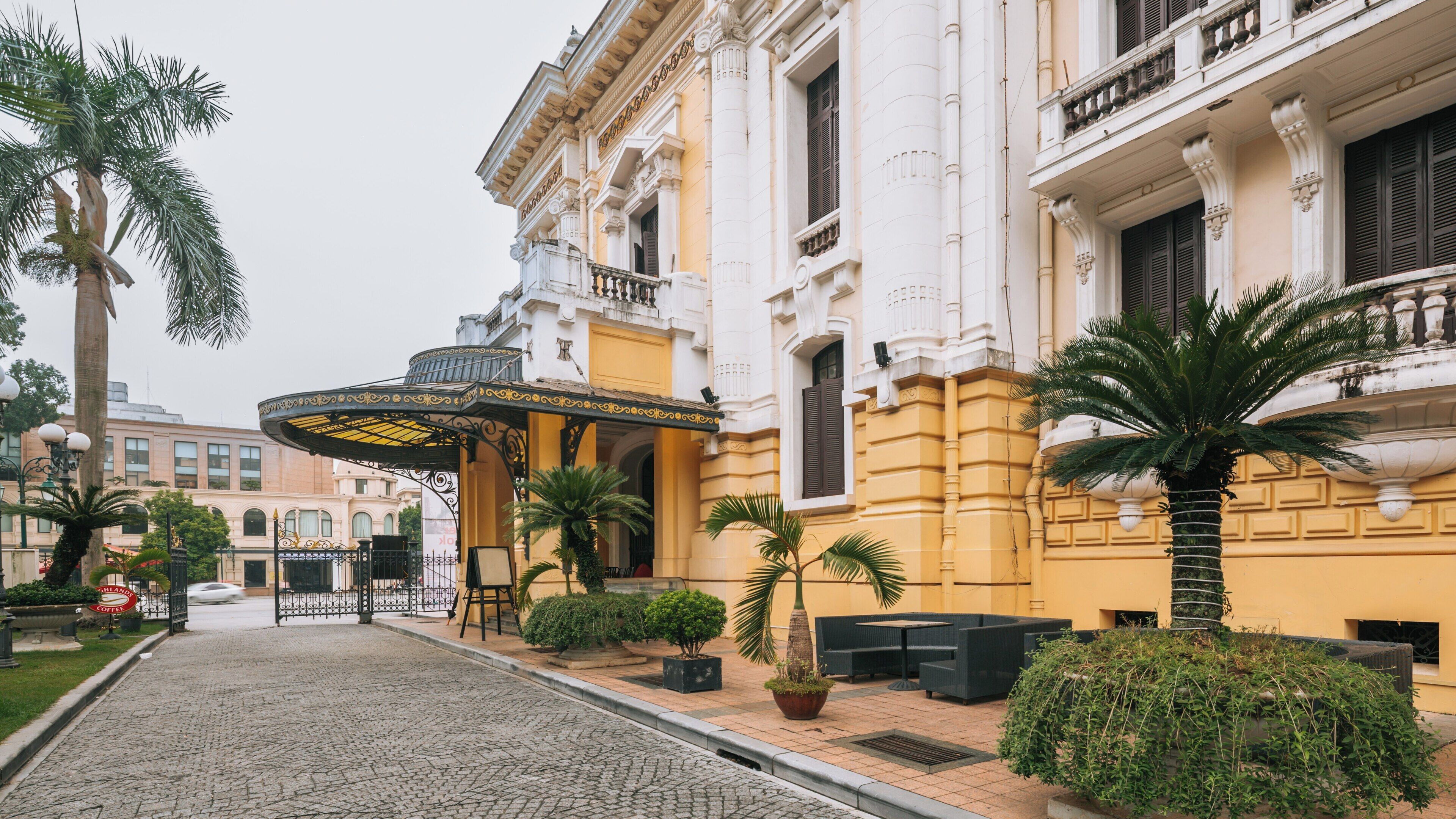 Hanoi Opera House in Hoan Kiem, Vietnam showcases elegant architecture and vibrant surroundings during a calm day