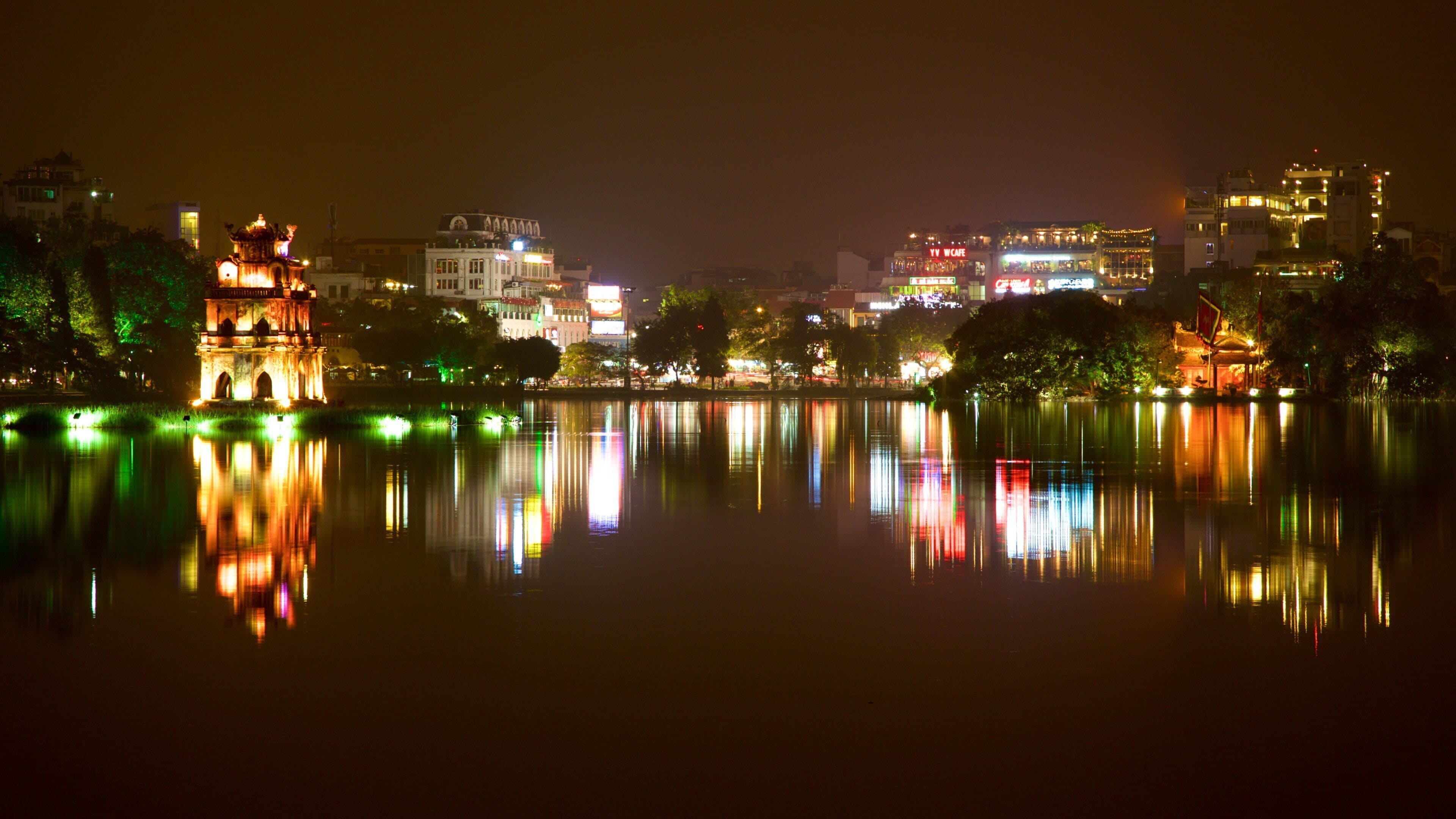 Hoan Kiem Lake featuring a lake or waterhole, a city and night scenes