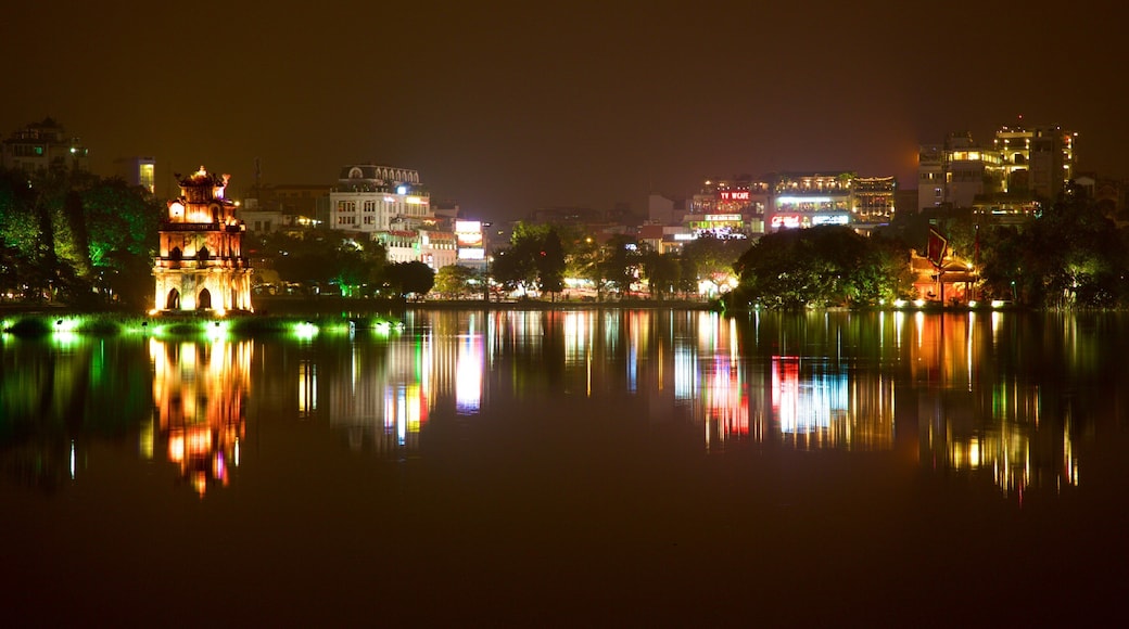 Hoan Kiem Lake featuring a lake or waterhole, a city and night scenes
