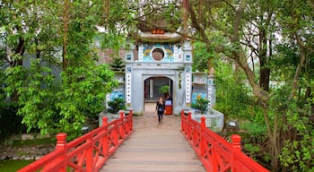 Ngoc Son Temple showing a bridge as well as an individual femail