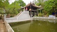 One Pillar Pagoda which includes a pond and a garden