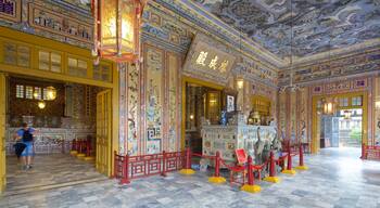 An ornately decorated interior with traditional Chinese architectural elements, including intricate murals and a prominent altar.