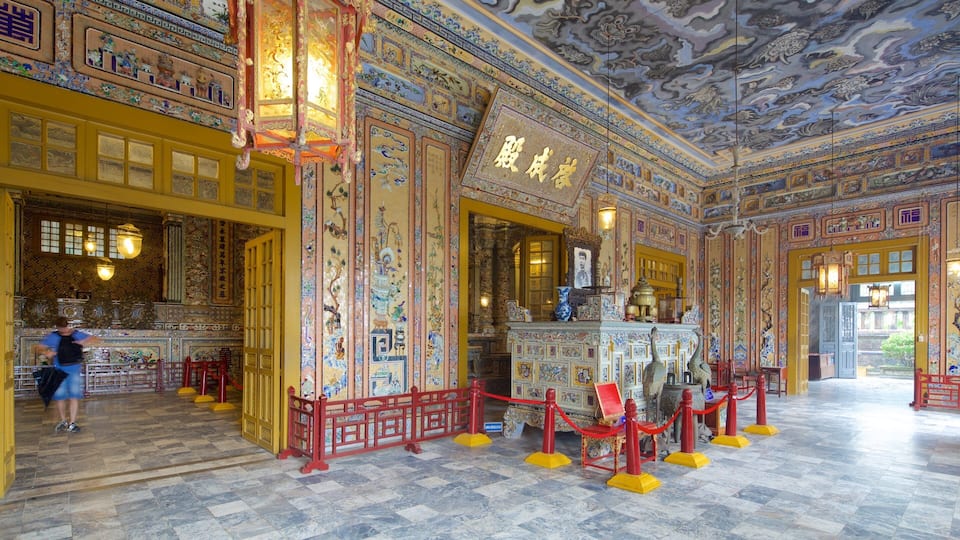 An ornately decorated interior with traditional Chinese architectural elements, including intricate murals and a prominent altar.