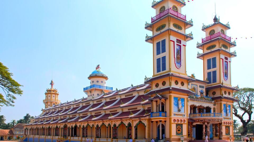 A large, ornate temple with multiple towers and a central dome, featuring intricate architectural details and statues.