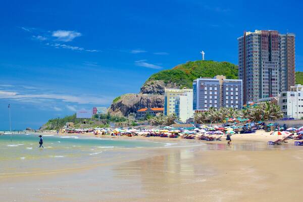 Back Beach featuring a coastal town and a sandy beach