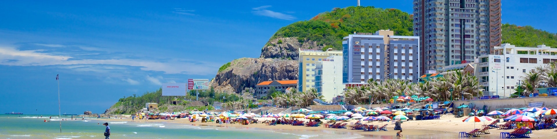 Back Beach featuring a coastal town and a sandy beach