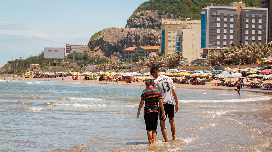 Back Beach featuring a beach and general coastal views as well as a family