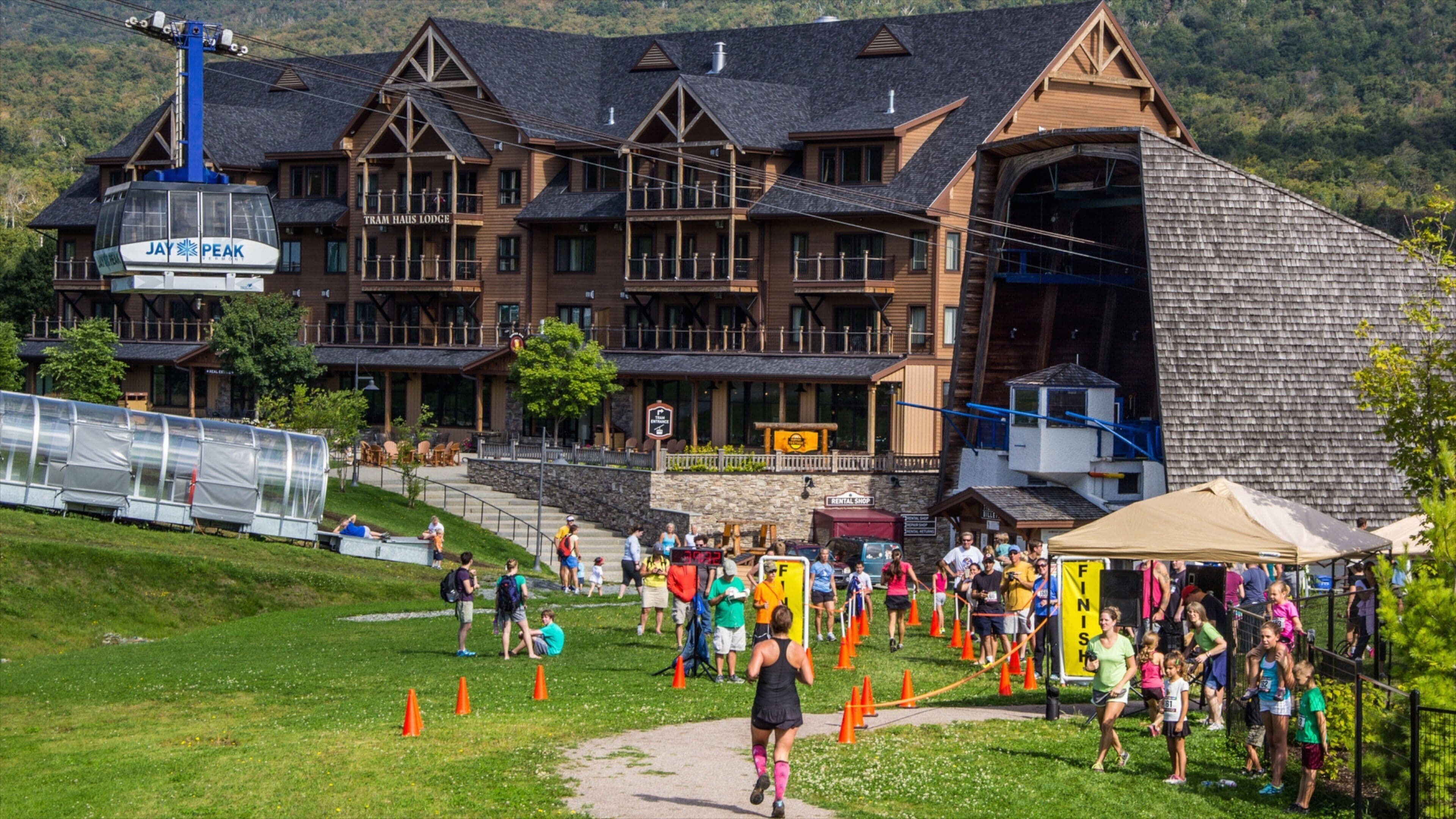A lodge with a ski lift, a running event, and a rental shop.
