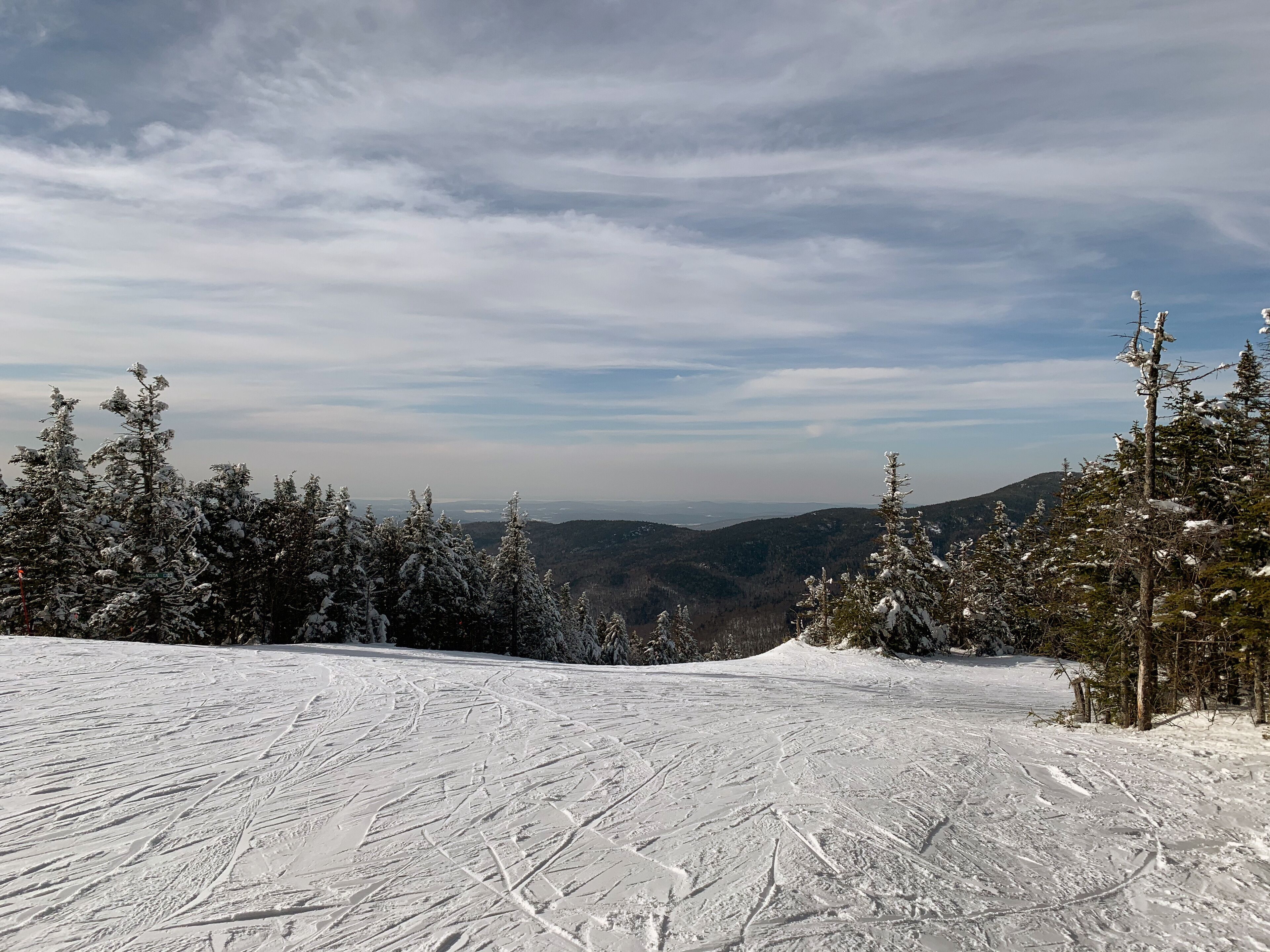East Coast United States Ski Resort view from atop a snow covered mountain. Vermont Skiing and Snowboarding, recreational, winter sports. 