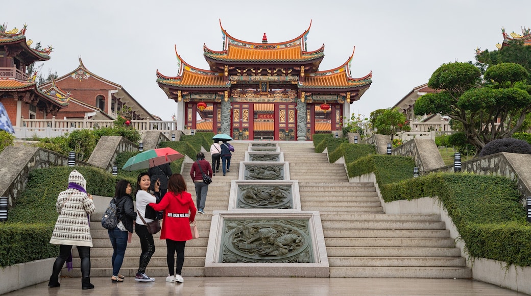 A-Ma Cultural Village featuring heritage elements and a garden as well as a small group of people