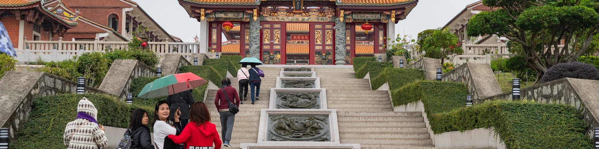 A-Ma Cultural Village featuring heritage elements and a garden as well as a small group of people