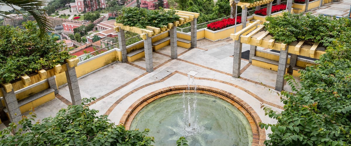 Chapel of our Lady of Penha featuring a fountain, a pond and landscape views