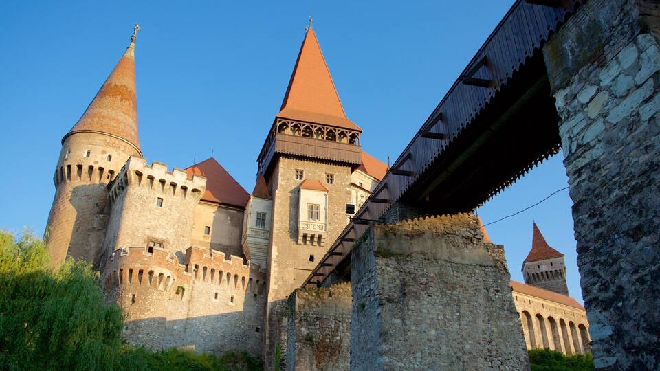 A historic castle with multiple towers and a stone bridge.