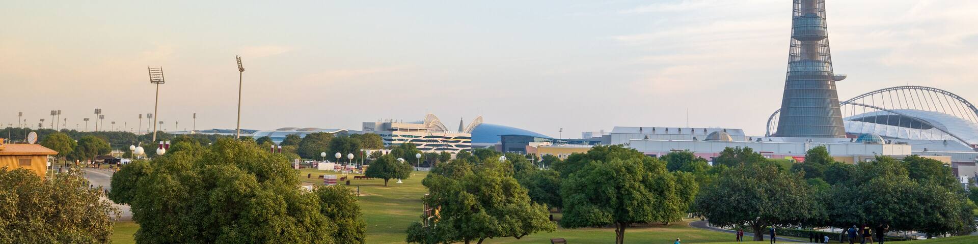 view of the aspire zone park with the view khalifa stadium and the aspire tower in the background.