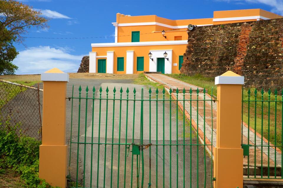 A historic building with a brick wall and a yellow facade.
