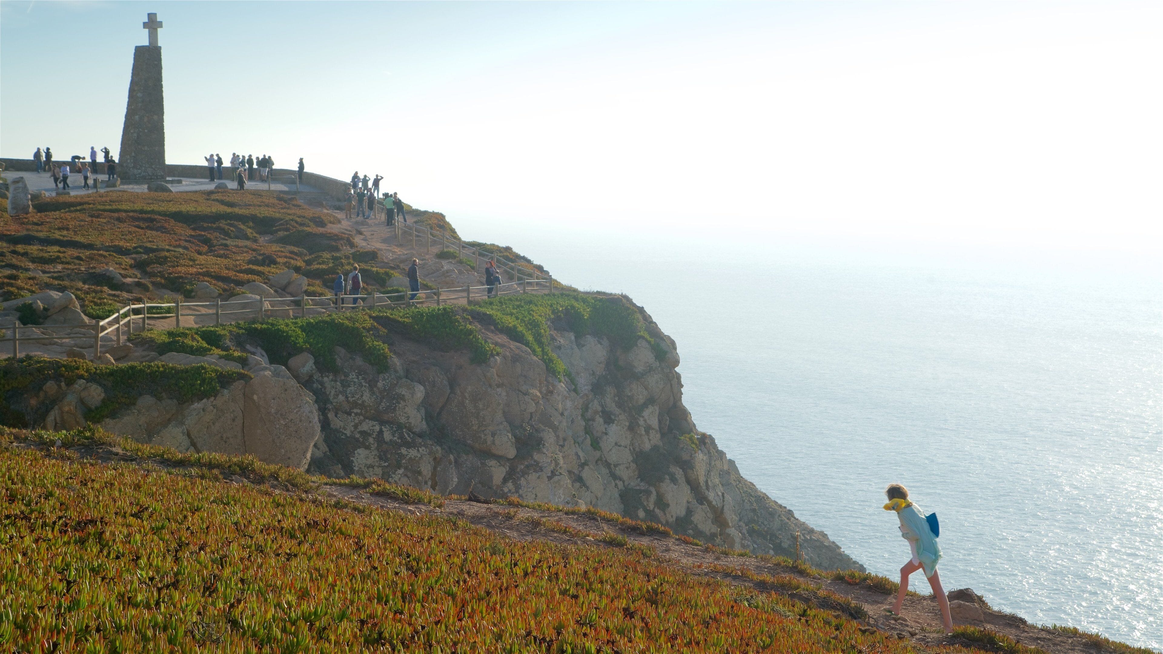 Cape Roca featuring general coastal views and religious aspects as well as a small group of people