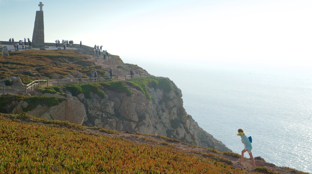 Cape Roca featuring general coastal views and religious aspects as well as a small group of people