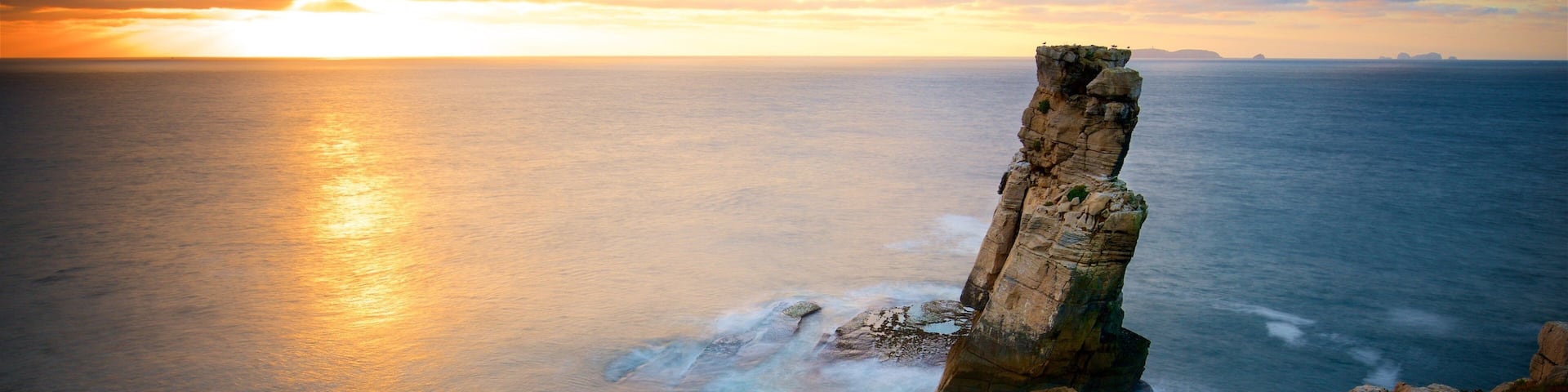 Cabo Carvoeiro showing general coastal views, a sunset and rocky coastline